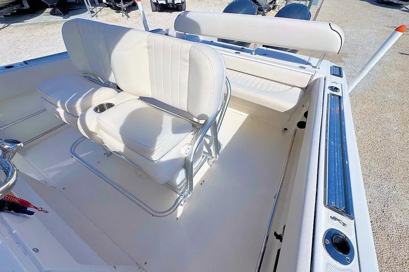 Slide: The Image of 2007 Robalo R240 Center Console boat interior with white seating and cup holders. - 6