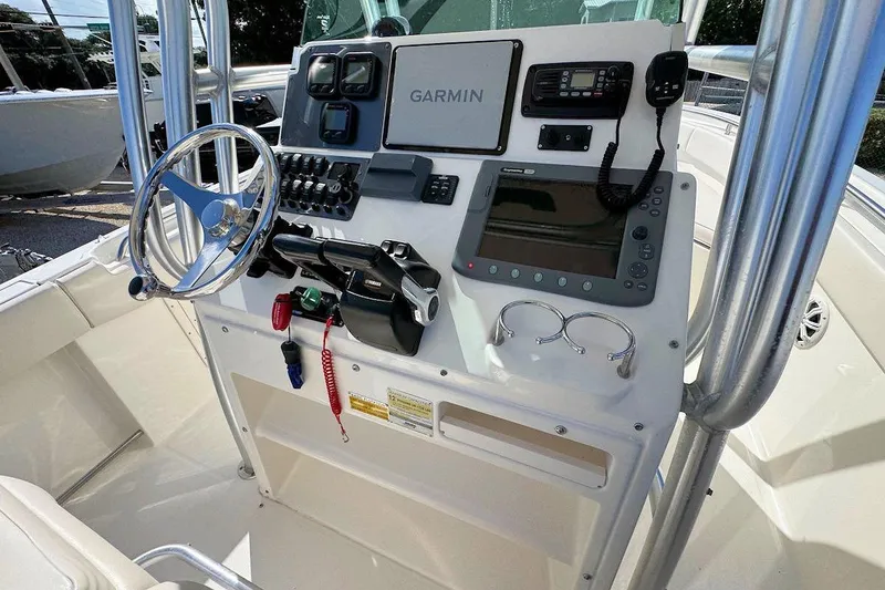 Slide: The Image of 2007 Robalo R240 Center Console boat dashboard with Garmin navigation system and controls. - 8