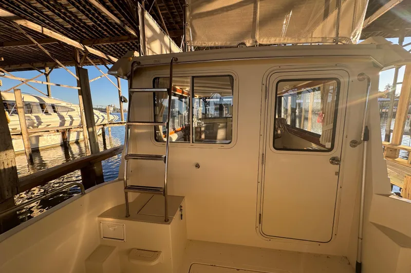 Slide: The Image of 2002 Camano Troller boat with logo and shadow on the hull. - 11