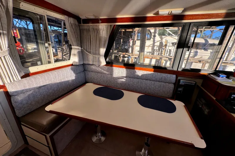 Slide: The Image of Interior of a 2002 Camano Troller with table and seating area. - 19