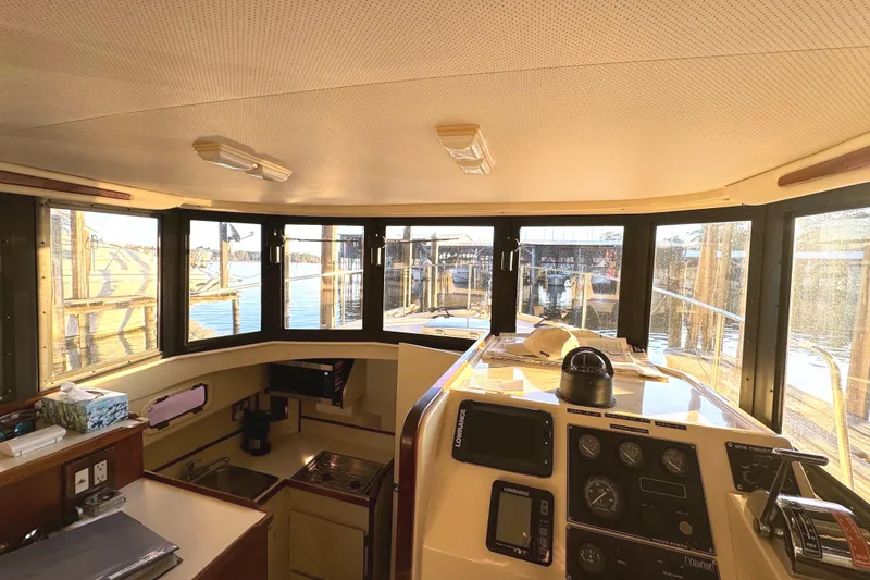 Slide: The Image of Close-up of 2002 Camano controls, featuring throttle and bow thruster switches. - 35