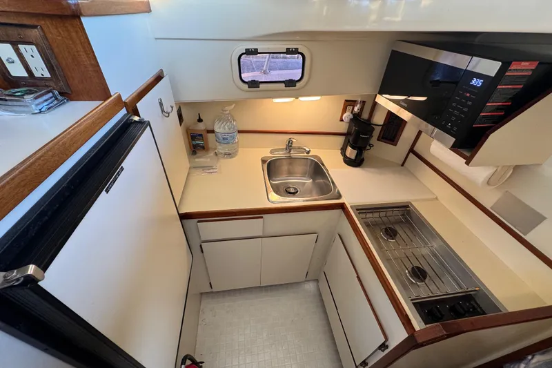 Slide: The Image of Small fridge inside a 2002 Camano Troller boat, stocked with beverages and food. - 41