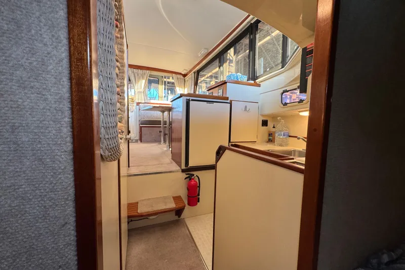 Slide: The Image of Compact kitchen in a 2002 Camano with sink, 2 burner Force 10 stove, and microwave & fridge with small freezer . - 44