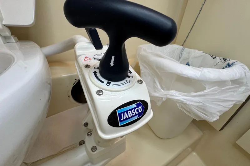 Slide: The Image of Control panel with switches for propane and water pump on a 2002 Camano Troller. - 48