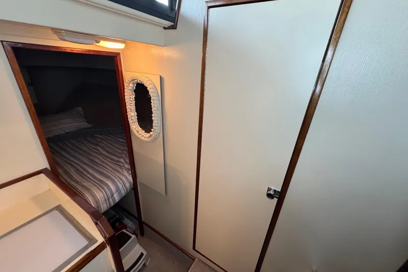 Slide: The Image of Interior cabin of 2002 Camano Troller boat with bed and wooden accents. - 54