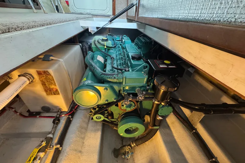 Slide: The Image of Engine compartment of a 2002 Camano Troll 31 boat, showcasing the engine and surrounding components. - 63