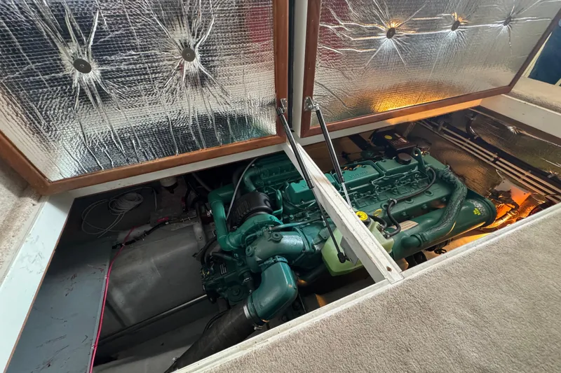 Slide: The Image of Engine compartment of a 2002 Camano Troll 31 boat, showcasing the engine and insulation. - 65