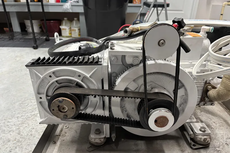 Slide: The Image of Engine component of a 2002 Camano Troll 31 boat, featuring belts and pulleys. - 69