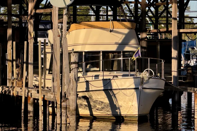 Slide: The Image of 2002 Camano Troller boat docked in a marina, showcasing its deck and cabin area. - 8