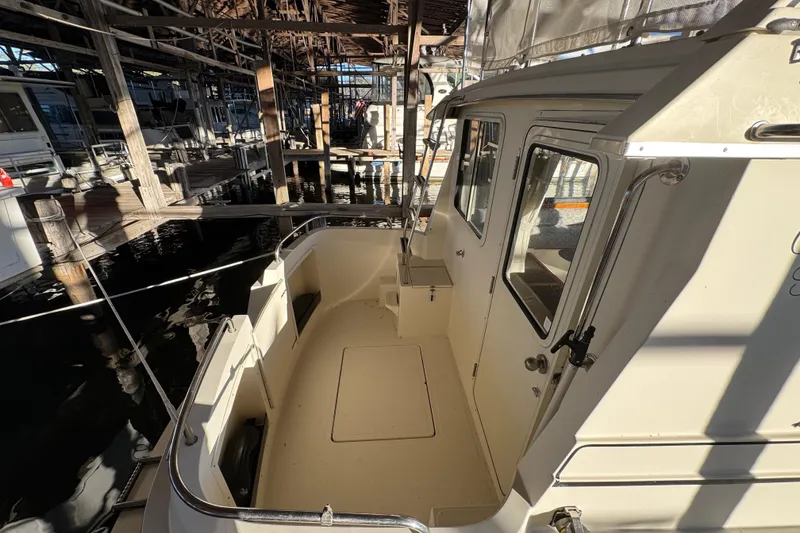 Slide: The Image of 2002 Camano Troller boat docked, showcasing side view and logo. - 9