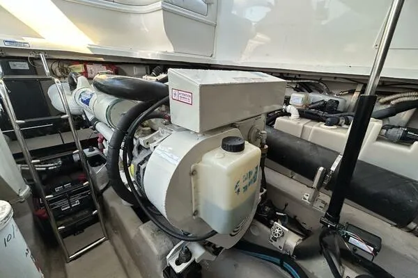 Slide: The Image of Engine compartment of 2003 Sea Ray 420 Sundancer, showcasing mechanical components and systems. - 16