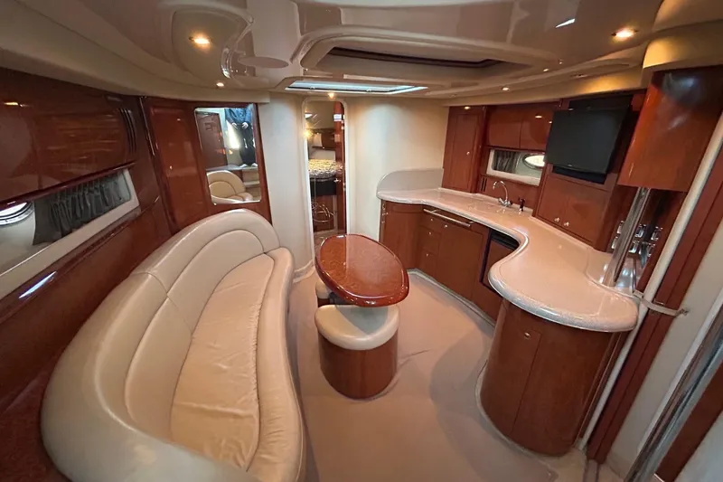 Slide: The Image of Luxurious interior of a 2003 Sea Ray 420 Sundancer yacht with elegant seating and kitchenette. - 4