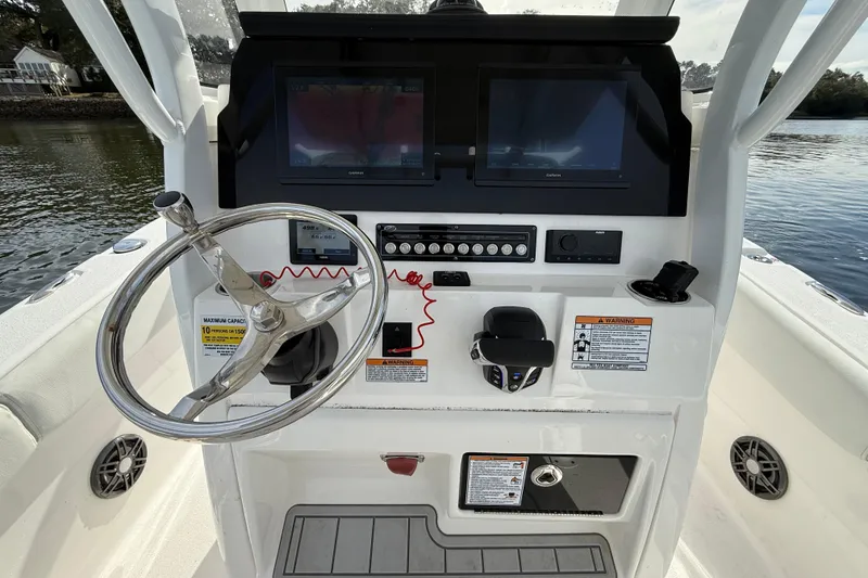 Slide: The Image of 2025 Sea Fox 248 Commander boat console with steering wheel and navigation screens. - 12