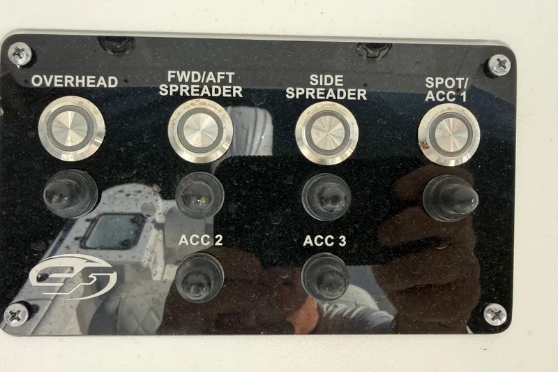 Slide: The Image of Control panel of a 2025 Sea Fox 248 Commander boat with labeled switches. - 19