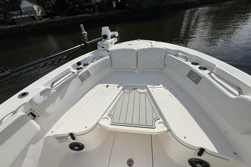 Slide: The Image of 2025 Sea Fox 248 Commander boat interior with seating and storage, on calm water. - 22