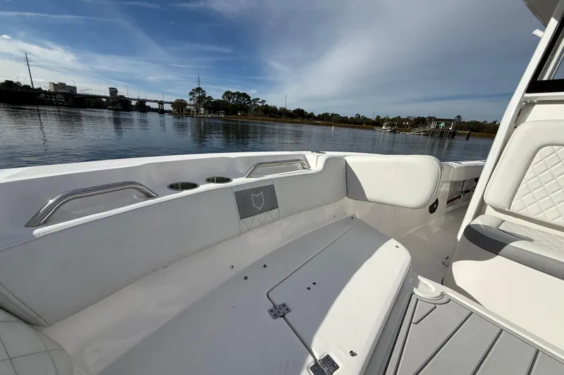 Slide: The Image of 2025 Sea Fox 248 Commander boat interior with seating, on a calm waterway. - 24