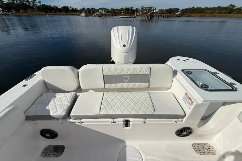 Slide: The Image of 2025 Sea Fox 248 Commander boat interior with cushioned seating and water view. - 25