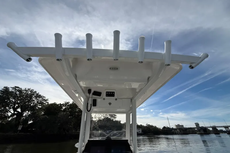 Slide: The Image of 2025 Sea Fox 248 Commander boat with rod holders, under a clear sky. - 27
