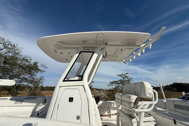 Slide: The Image of 2025 Sea Fox 248 Commander boat with T-top and seating, under clear blue sky. - 30