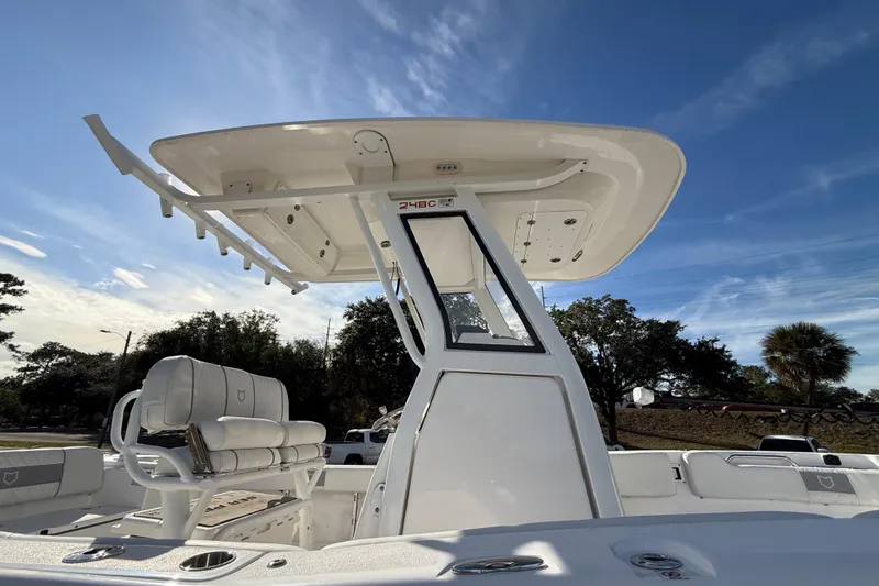 Slide: The Image of 2025 Sea Fox 248 Commander boat with T-top and seating, under clear blue sky. - 31