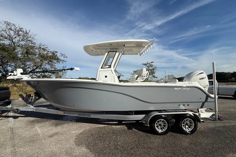 Slide: The Image of 2025 Sea Fox 248 Commander boat on trailer, parked outdoors under a clear sky. - 6