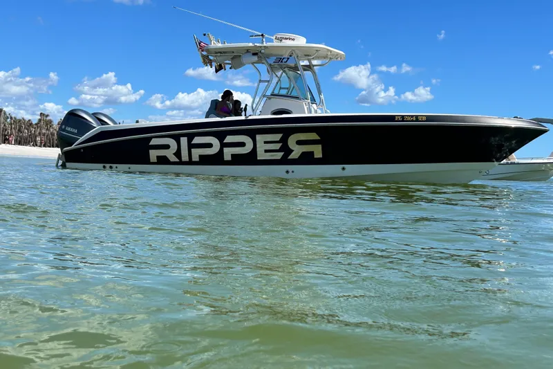 The Image of 2012 Wellcraft 30 Scarab Offshore Sport boat on water, clear sky background. - 1