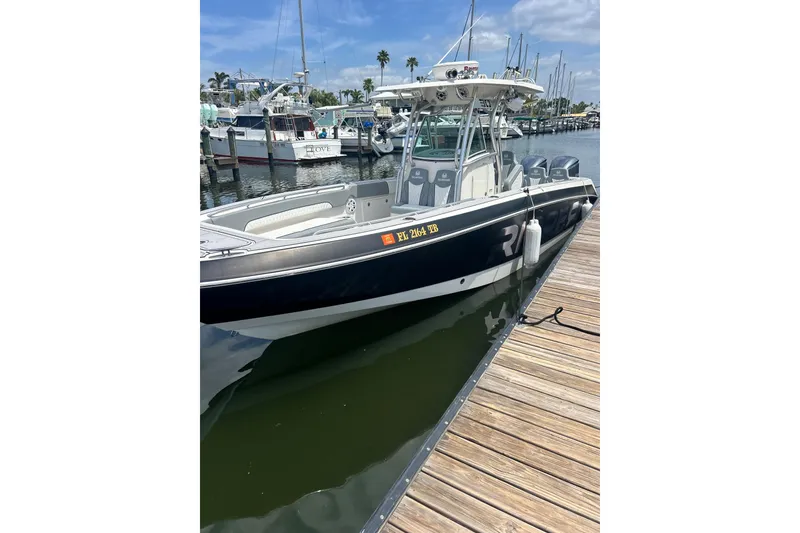 Slide: The Image of 2012 Wellcraft 30 Scarab Offshore Sport boat docked at marina. - 3