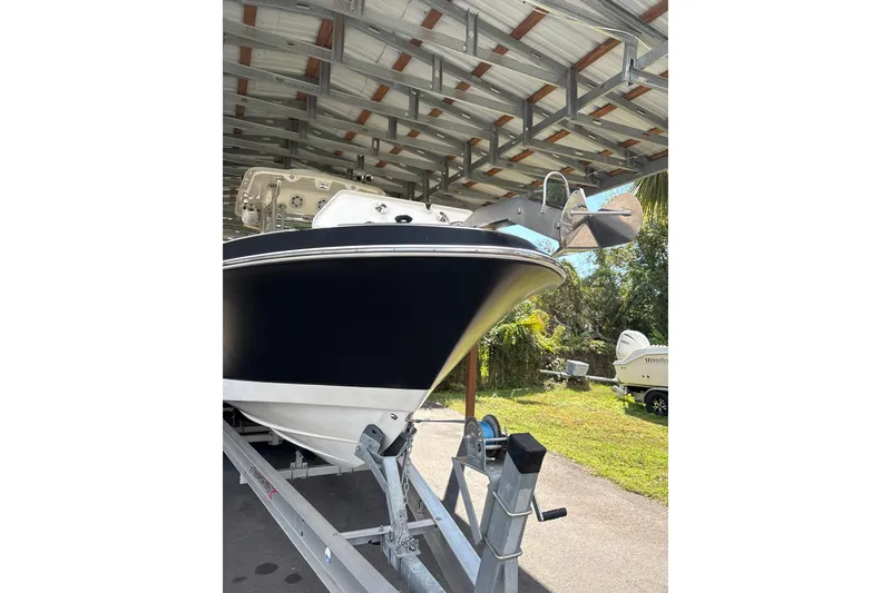 Slide: The Image of 2012 Wellcraft 30 Scarab Offshore Sport boat on trailer under shelter. - 5