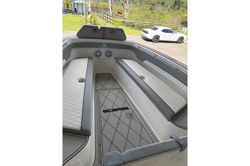 Slide: The Image of 2012 Wellcraft 30 Scarab Offshore Sport boat interior with cushioned seating and sleek design. - 6