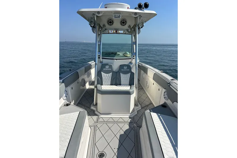 Slide: The Image of 2012 Wellcraft 30 Scarab Offshore Sport boat interior with seating and ocean view. - 7