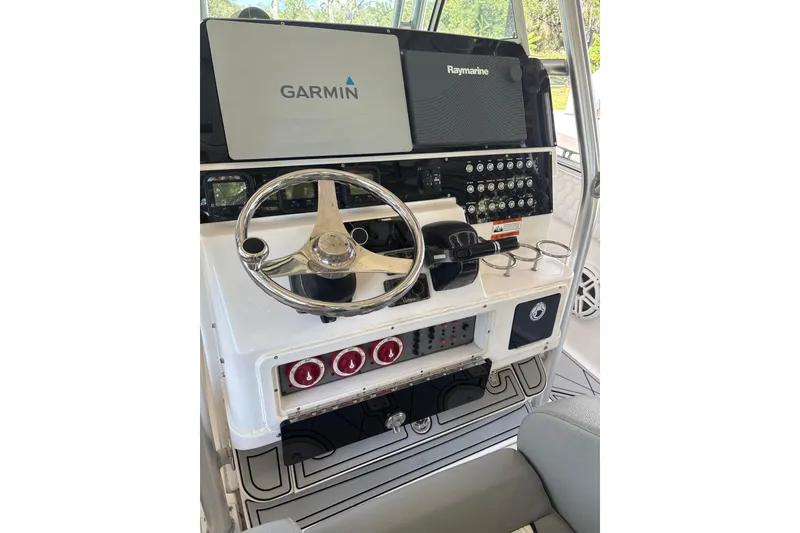 Slide: The Image of 2012 Wellcraft 30 Scarab Offshore Sport helm with Garmin and Raymarine displays. - 9