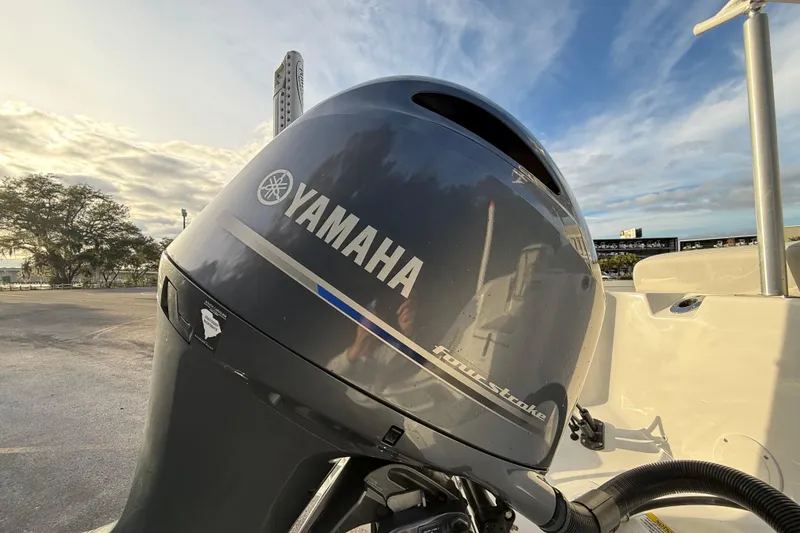 Slide: The Image of Yamaha outboard motor on 2021 Sea Fox 228 Commander boat, parked under a cloudy sky. - 12