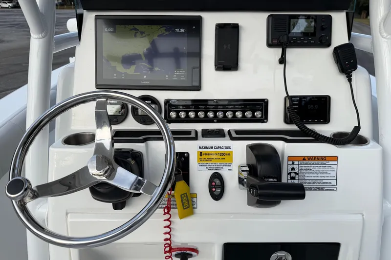 Slide: The Image of 2021 Sea Fox 228 Commander dashboard with steering wheel, navigation, and communication equipment. - 13