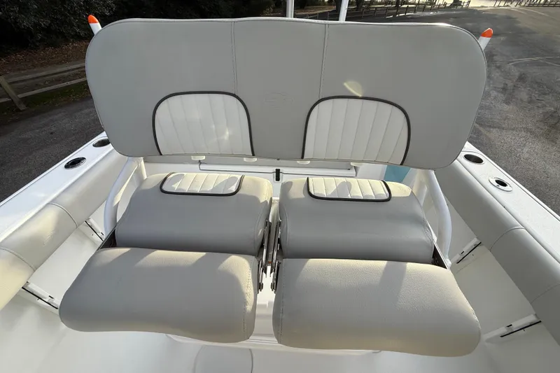 Slide: The Image of 2021 Sea Fox 228 Commander boat seating, featuring cushioned dual seats and backrest. - 21