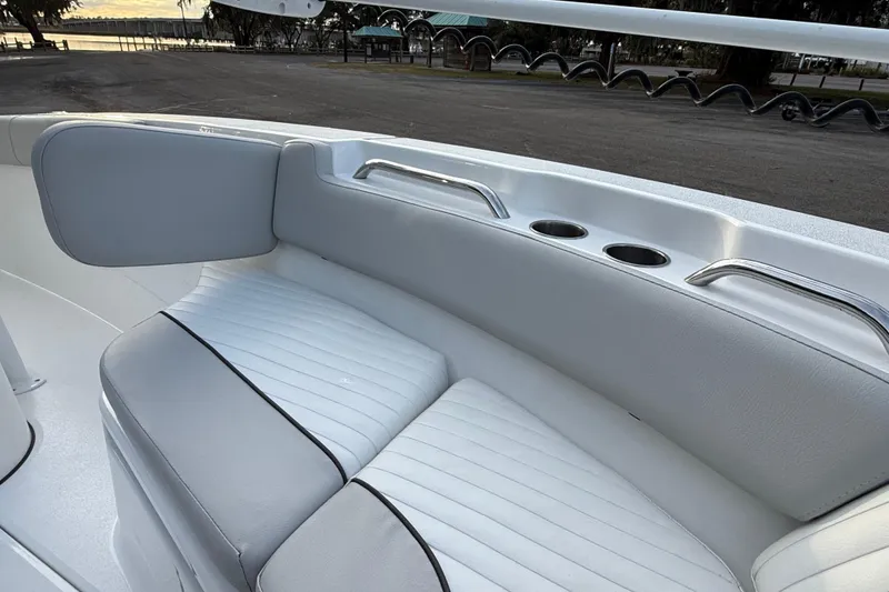 Slide: The Image of 2021 Sea Fox 228 Commander boat interior with cushioned seating and cup holders. - 26