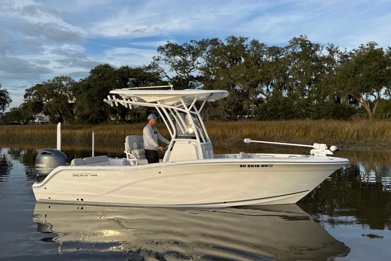Slide: The Image of 2021 Sea Fox 228 Commander boat on calm water with scenic background. - 3