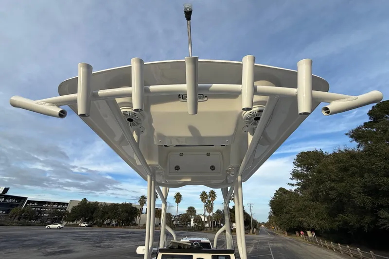 Slide: The Image of 2021 Sea Fox 228 Commander boat with T-top and rod holders against a blue sky. - 32