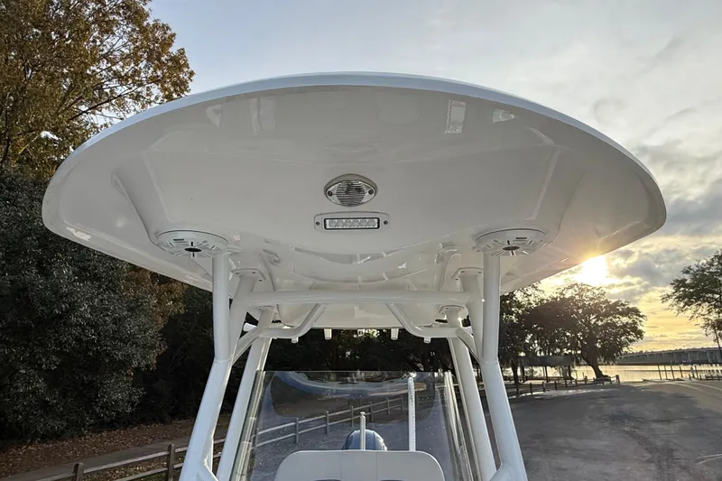Slide: The Image of 2021 Sea Fox 228 Commander boat T-top with speakers and lighting at sunset. - 33