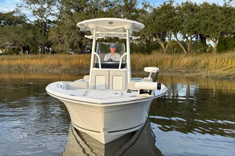 Slide: The Image of 2021 Sea Fox 228 Commander boat on calm water near grassy shoreline. - 4