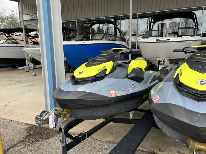 Slide: The Image of 2021 Sea-Doo Gti Se 170 jet skis on trailer outside boathouse. - 7