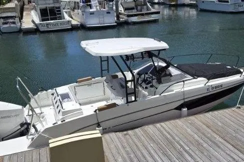 Slide: The Image of 2024 Beneteau Oceanis 281 docked in a marina, featuring sleek design and modern amenities. - 2