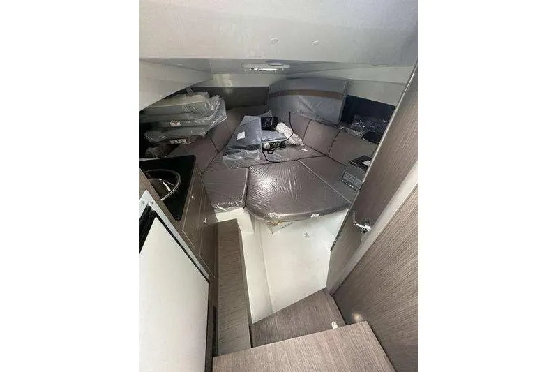 Slide: The Image of Interior of 2024 Beneteau Oceanis 281 sailboat, featuring modern seating and compact design. - 4