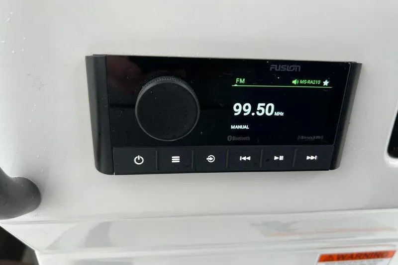 Slide: The Image of Fusion marine radio display on 2024 Beneteau Oceanis 281, tuned to 99.50 MHz FM. - 6