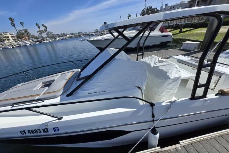 Slide: The Image of 2024 Beneteau Oceanis 281 docked at marina, sleek design, sunny day. - 8