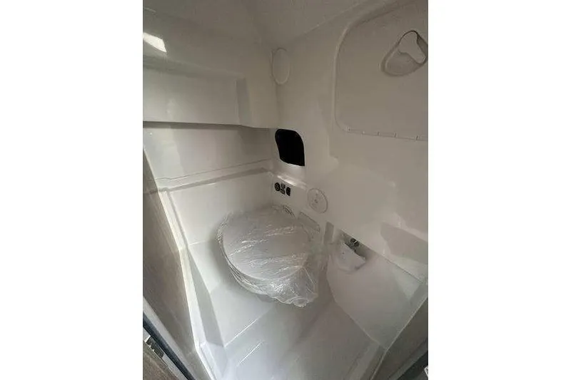 Slide: The Image of 2024 Beneteau Oceanis 281 yacht bathroom interior with compact design and modern fixtures. - 9