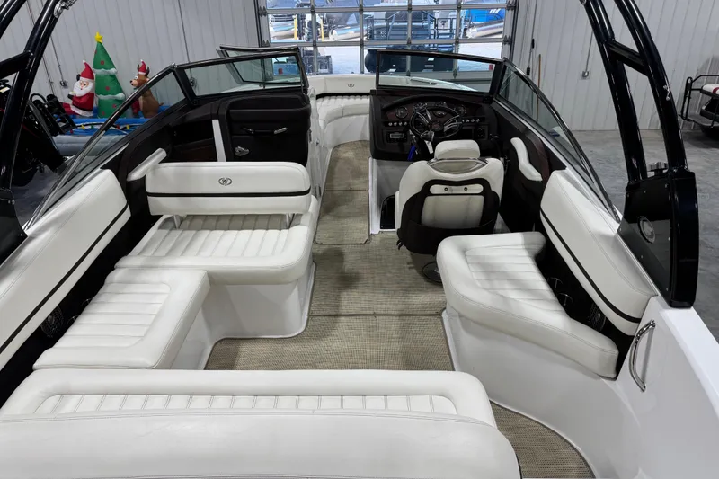 Slide: The Image of 2015 Cobalt R5 boat interior with white seating and modern dashboard. - 11