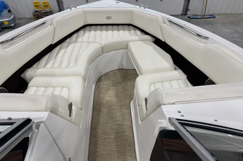 Slide: The Image of 2015 Cobalt R5 boat interior with white cushioned seating and carpeted floor. - 7