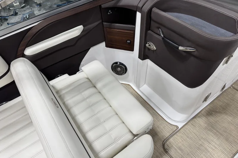 Slide: The Image of Interior of a 2015 Cobalt R5 boat with white leather seats and wood accents. - 8