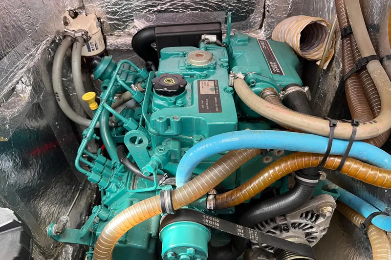 Slide: The Image of Engine compartment of a 2007 Delphia 33 Sloop, featuring a well-maintained marine engine. - 100