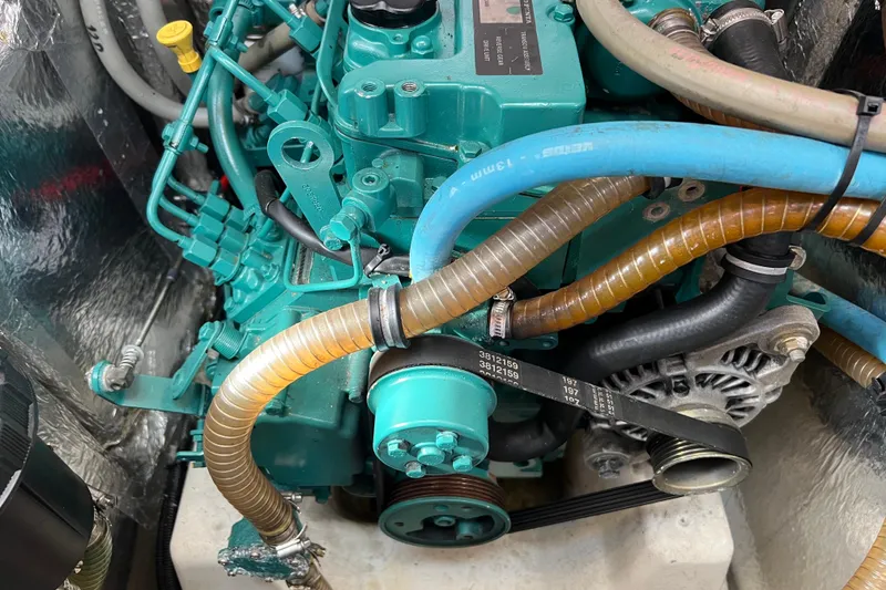 Slide: The Image of Engine compartment of a 2007 Delphia 33 Sloop with visible hoses and components. - 101